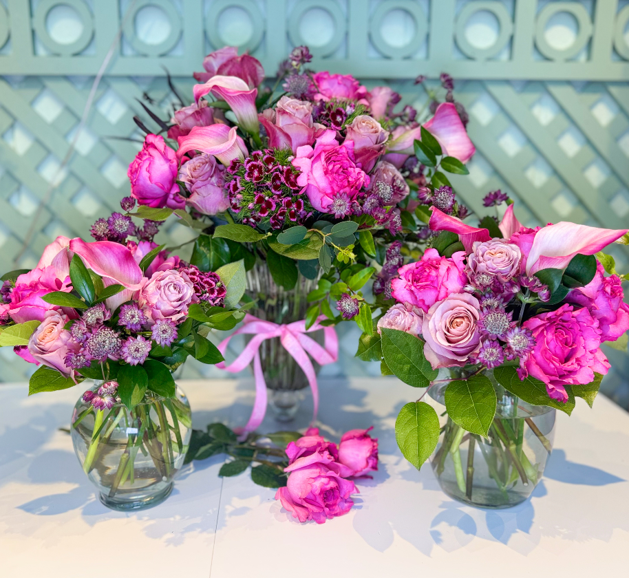 Three pink valentines day bouquets on a white table.